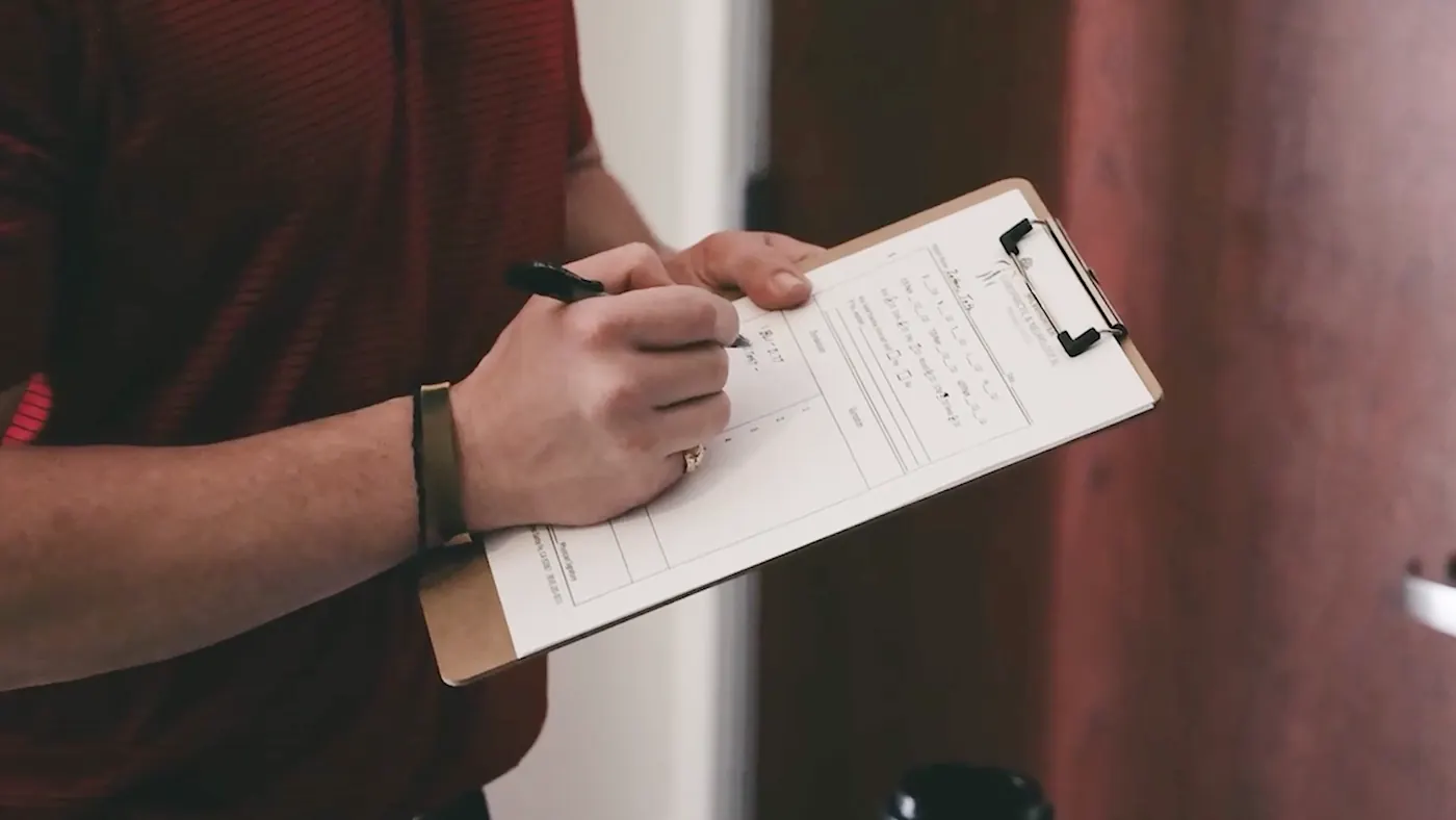 Dr. Jeff McWhorter, D.C., writing notes on a clipboard