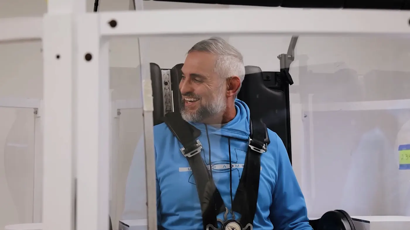 A patient harnessed in the GyroStim chair, smiling