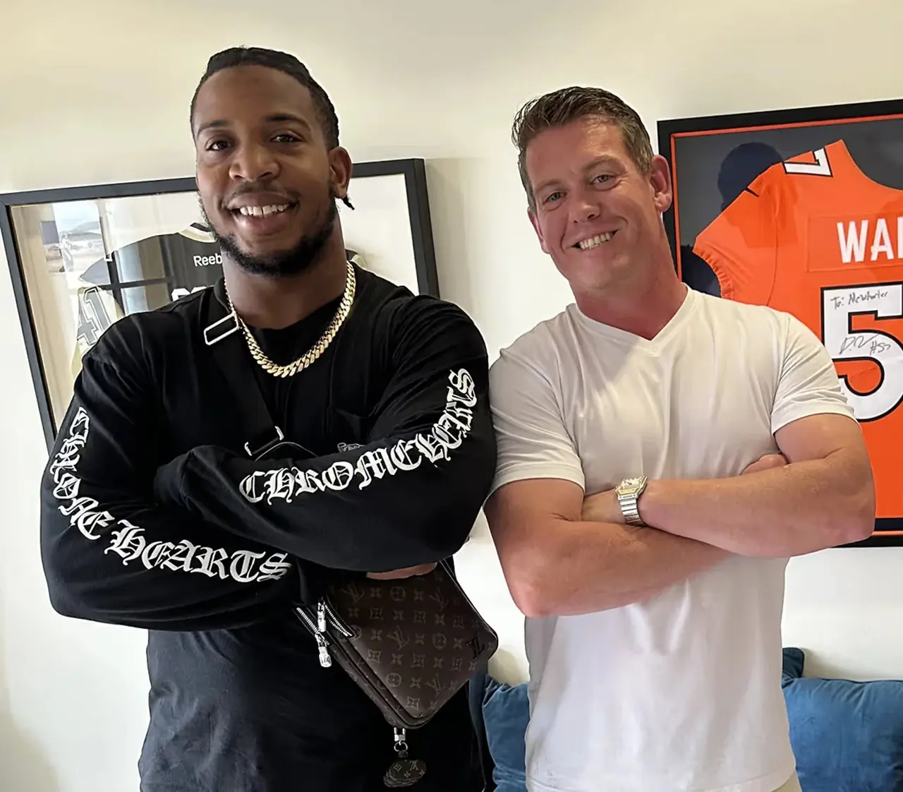 DeMarcus Walker with Dr. Jeff McWhorter DeMarcus Walker and Dr. Jeff McWhorter standing arms crossed in front of a framed jersey