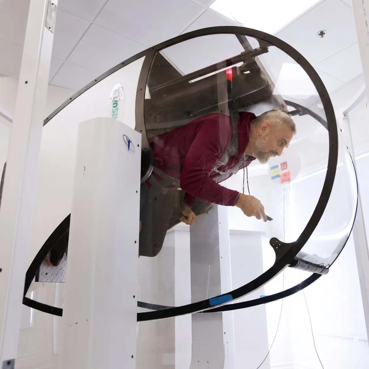 GyroStim motion training Man in the GyroStim chair aiming a laser pointer during rotation