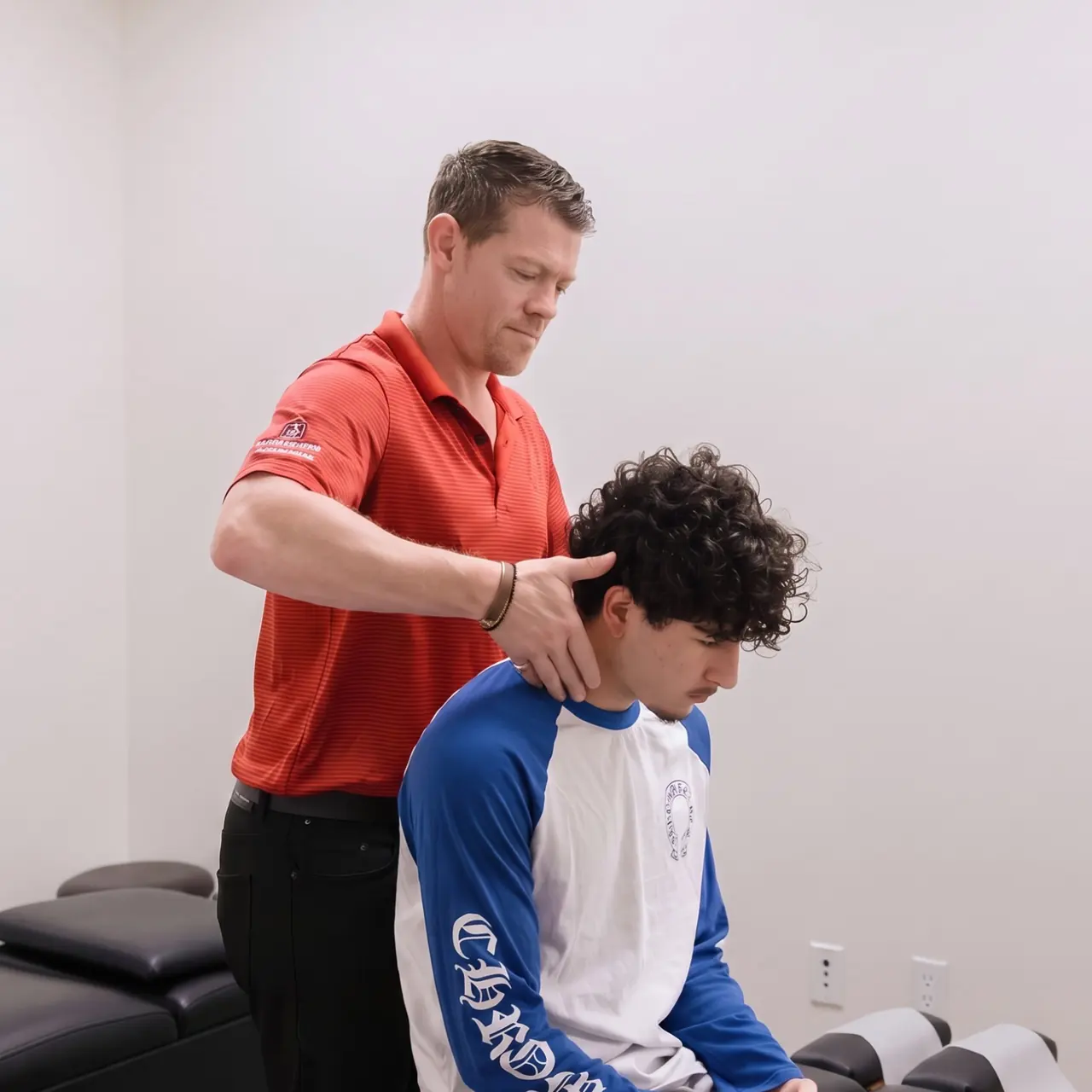Seated neck adjustment Chiropractor positioning a seated patient's head before a neck adjustment