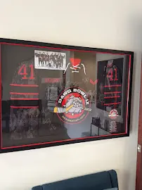Framed DAWG Bowl IX charity hockey tournament plaque with signed jerseys