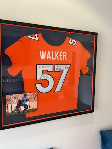 Framed signed orange Walker number 57 jersey