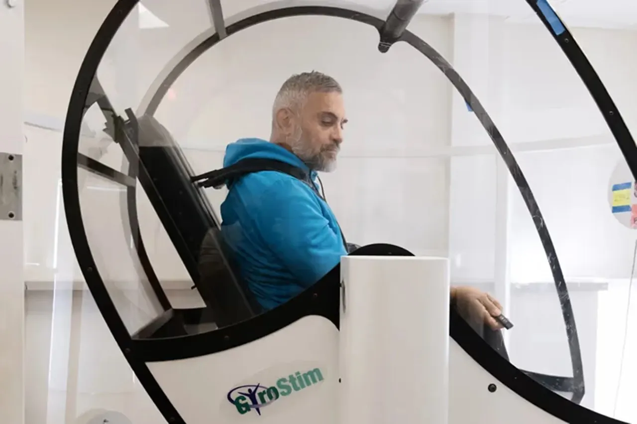 GyroStim session Patient seated in the GyroStim chair during a balance training session